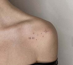 the back of a woman's shoulder with small stars on it