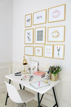 a white desk with lots of pictures on the wall