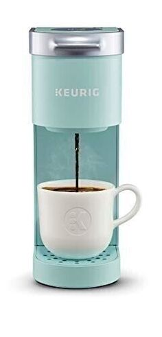 the keurig single serve coffee maker is shown with its cup filled with liquid