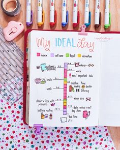 an open planner with markers and pens on it