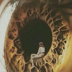 a man sitting in front of an eye looking up