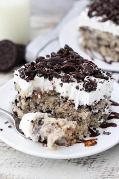 a slice of oreo cookie cake on a white plate with a fork next to it