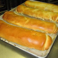 four loafs of bread sitting on top of a pan