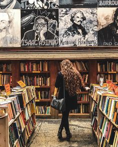 a woman walking through a library filled with books