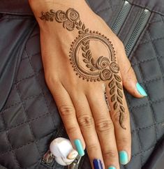 a woman's hand with a henna tattoo on it