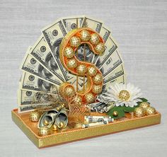 a dollar bill and some gold decorations on a table