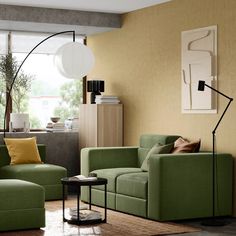 a living room with two couches and a lamp in the corner on the wall