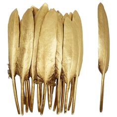 a group of gold colored feathers sitting on top of each other