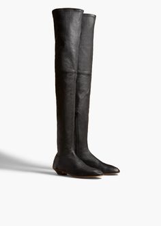 Description A sleek, over-the-knee boot shaped by softened lines, including a rounded toe inspired by that of the classic ballet flat. With side zipper. Details Material: Stretch nappa lamb (100% lambskin) Care: Clean professionally by leather expert Fit: Runs true to size Origin: Made in Italy Khaite Boots, Luxury Knee-high Calf Leather Boots With Leather Sole, Luxury Sleek Leather Knee-high Boots, Designer Black Knee-high Boots With Leather Sole, Luxury Black Suede Knee-high Boots, Fall Handbags, Belt Accessories, Oliver Peoples, Flat Boots