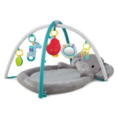 an elephant play mat with toys hanging from it