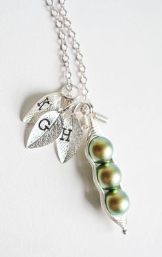 I wrap iridescent green color crystal pearls in wire to make them look like these really cute little pea pods! You can choose your desired pea count and add hand-stamped leaf charms with initials. Perfect gift for mothers and grandmothers (to be), as well as baby shower gifts! Some like to request these as matching best friends or bridesmaids necklaces as well. Each crystal pearl measures at 8mm. One pod can fit up to 5 crystal pearls. If you need it to represent more than that, you can request Green Pearl Jewelry For Gifts, Green Pearl Necklace For Gifting, Green Pearl Necklace As A Gift, Green Nickel-free Jewelry For Mother's Day, Whimsical Green Nickel-free Jewelry, Cute Green Jewelry Gift, Whimsical Green Jewelry For Gifts, Bridesmaids Necklaces, Necklace Best Friends