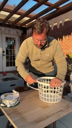 a man is working on something in a basket