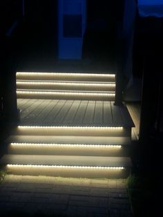 some steps lit up with white lights in the dark at night, and there is no image here to provide a caption for