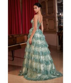 Step into enchantment with this sultry A-line ball gown—a bewitching fusion of glamour and allure. The layered tiered scalloped sequin ruffled skirt creates a mesmerizing play of light, ensuring every step is a symphony of elegance. The sheer bodice, adorned with shimmering lace appliqué, adds a touch of opulence, allowing your radiant beauty to shine through. Delicate thin straps frame a captivating v-neckline, striking a perfect balance between sophistication and sultry charm. It's not just a dress; it's an ode to the empowered, sultry enchantress within you. With each scallop, sequin, and lace flourish, let this gown be your expression of feminine allure, leaving an indelible mark on hearts and memories as you captivate the night with every twirl.Available in sizes 2-18 while supplies l Tiered Prom Dress, Radiant Beauty, Cinderella Divine, Ruffled Skirt, Dress 16, Ruffle Skirt, Lace Applique, Ball Gown, Pretty Dresses