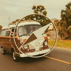 an old vw bus driving down the road