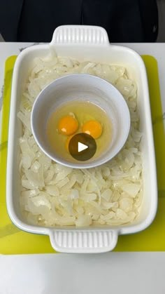 an egg is in a bowl on top of rice