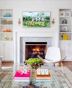 a living room filled with furniture and a fire place in front of a white fireplace