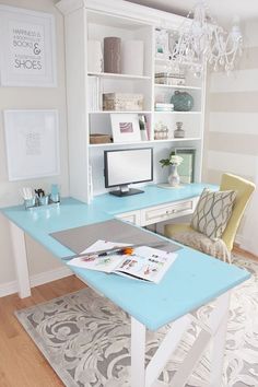 a desk with a computer on top of it in front of a book shelf and chair