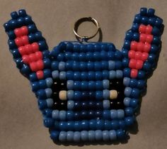 a blue and red beaded keychain hanging from a hook