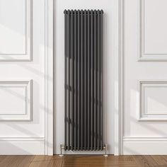 a black radiator in front of a white door