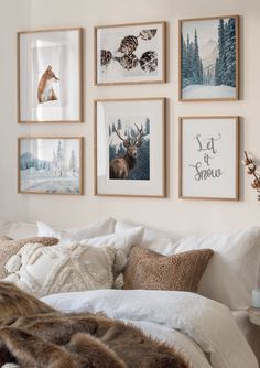 a bedroom with pictures on the wall above the bed and fur throw blanket in front of it