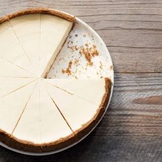 a cheesecake on a plate with one slice missing