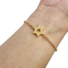 "This beautiful and stylish small gold Star of David bracelet is a staple piece of jewelry in anyone's wardrobe. The Star of David has long been a popular decorative motif on all sorts of Judaica, jewelry and art, owing to its beautiful geometric symmetry as well as its deep and powerful symbolism. 14K Gold Star of David Link Bracelet: Symbolic Elegance and Quality Craftsmanship for Meaningful Style Statements. This bracelet is a beautiful work of art that will make a precious gift to last for a lifetime. The jewelry will be packed in a gift box. Size: 14mm x 12mcm / 0.55\" x 0.45\" Dear Buyer,  My name is Rafael and my goal is to give you the best buying experience on Etsy I have a lot of experience in customer relations selling on the internet, and my goal is your 100% satisfaction guara Gold Metal Bracelet With Star Charm, Gold Metal Bracelets With Star Charm, Gold Metal Chain Bracelet With Star Charm, Adjustable Gold Star-shaped Chain Bracelet, Gold Star Charm Chain Bracelet, Gold Chain Bracelet With Star Charm, Adjustable Gold Star Chain Bracelet, Star-shaped Metal Bracelets As Gifts, Gold Bracelet With Star Charm As Gift