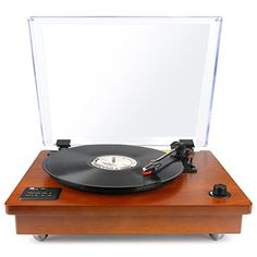 an old fashioned record player sitting on top of a wooden table