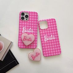 two cell phones sitting next to each other on top of a white table with pink hearts