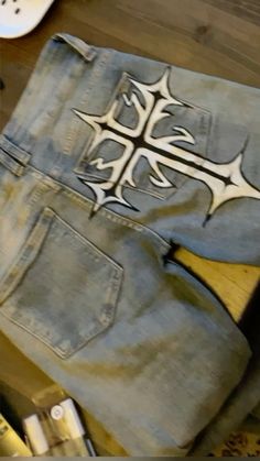 a pair of jeans with an artistic design on them