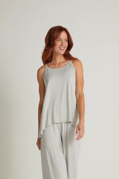 The swish and sway of the crossover Tulip Tank with a scooped hemline lends elegance to our coziest pajamas ever. The gathered backstrap of the loose fit tulip top fine-tunes the fit for carefree comfort. Made from our signature Faceplant Bamboo blend, this collection inspires fluid movement. Dance. Play. Dream. In The Tulip you’ll look as good as you feel. Adjustable backstrap Complete your look with the Tulip Pants and Tulip Shorts Modal Tops With Built-in Bra For Loungewear, Casual Tops With Built-in Bra For Lounging, Spring Tank Loungewear Sleepwear, Modal Scoop Neck Camisole For Loungewear, Comfortable Scoop Neck Top For Loungewear, Casual Scoop Neck Camisole For Loungewear, Comfy Summer Tops For Relaxation, Casual Sleep Tops With Built-in Bra, Spring Scoop Neck Sleepwear For Loungewear