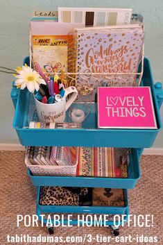 a blue cart filled with lots of crafting supplies on top of a carpeted floor