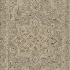 a beige rug with an intricate design