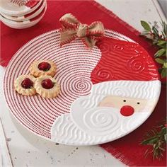 a white plate topped with pastries and a santa clause face