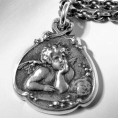 Sterling Silver Cherub Baby Guardian Ange Necklace by oas New York™ One of the most recognizable iconic images in the world, the cherub from Sistine Madonna, one of the last Madonnas painted by the artist Raphael. Unlike other cherub pendants on the market, our piece offers you the thickness and detail of old world silversmithing. Necklace is 18 inches long, with 16 inches alternative (jump rings on 18 & 16 inch mark). The solid sterling chain is antiqued to assume the genteel patina of age. Antique Sterling Silver Necklace Personalized, Sistine Madonna, Cherub Baby, Angel Pendant Necklace, Angel Charm, Iconic Images, Face Necklace, Angel Pendant, Owl Necklace