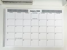 a calendar is hanging on a white wall