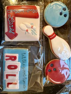 three decorated cookies in the shape of bowling pins