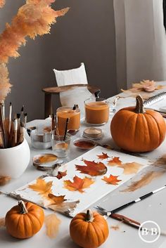 a white table topped with lots of pumpkins