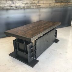 a wooden table sitting on top of a white floor next to a metal frame wall