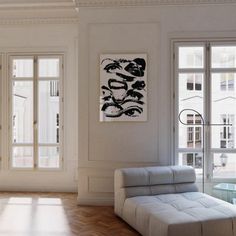 a living room with white walls and wooden floors