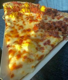 two slices of pizza sitting on top of a white plate