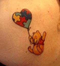 a tattoo with a teddy bear holding a heart shaped balloon