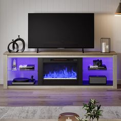 a living room with a large television and fire place in front of the flat screen tv