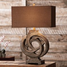 a wooden table lamp with a brown shade