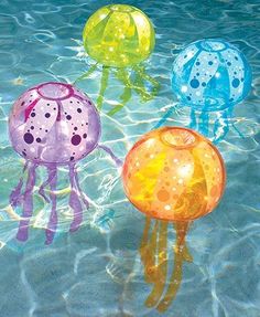 four jellyfish floating on top of a swimming pool