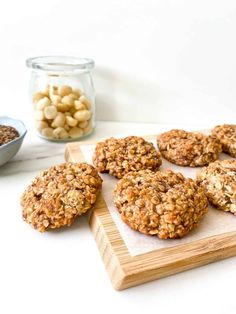 several cookies on a cutting board next to some nuts