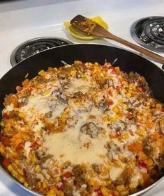 a pan filled with food sitting on top of a stove