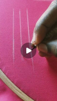 someone is stitching on the fabric with a pair of scissors to make it look like they're making something