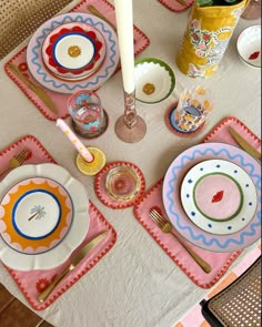 the table is set with colorful plates and utensils