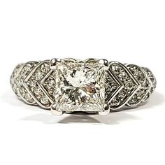 an antique style diamond ring with filigrees